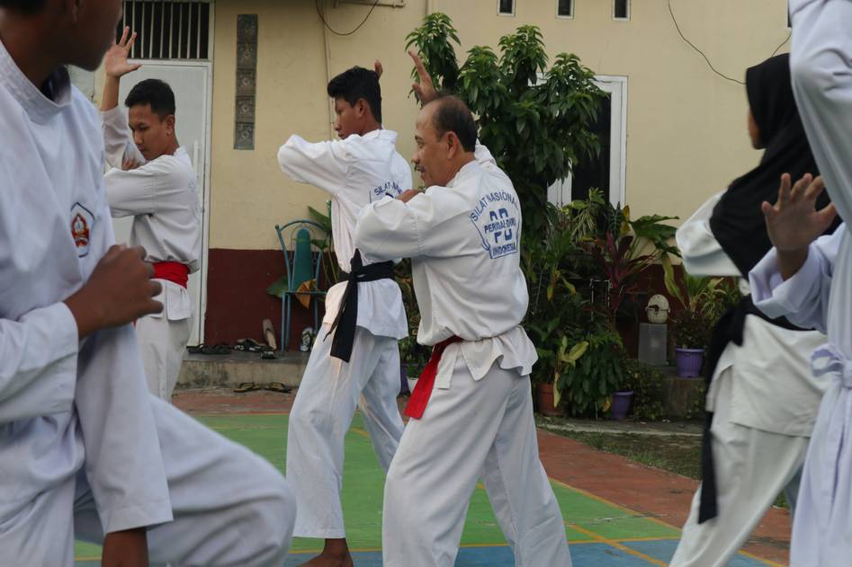 Martial artist practicing disciplined kata form outdoors at sunrise