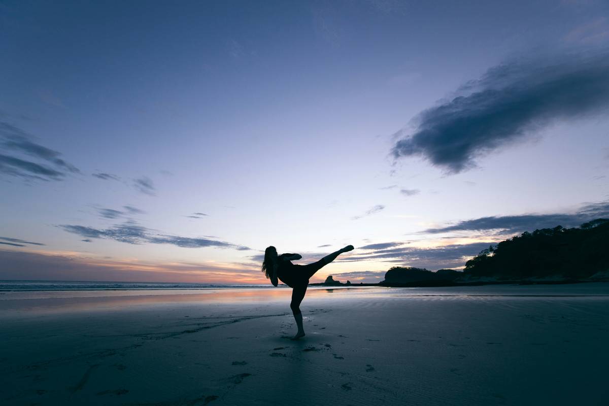 Woman practicing Krav Maga self-defense moves – benefits of martial arts training shown in action
